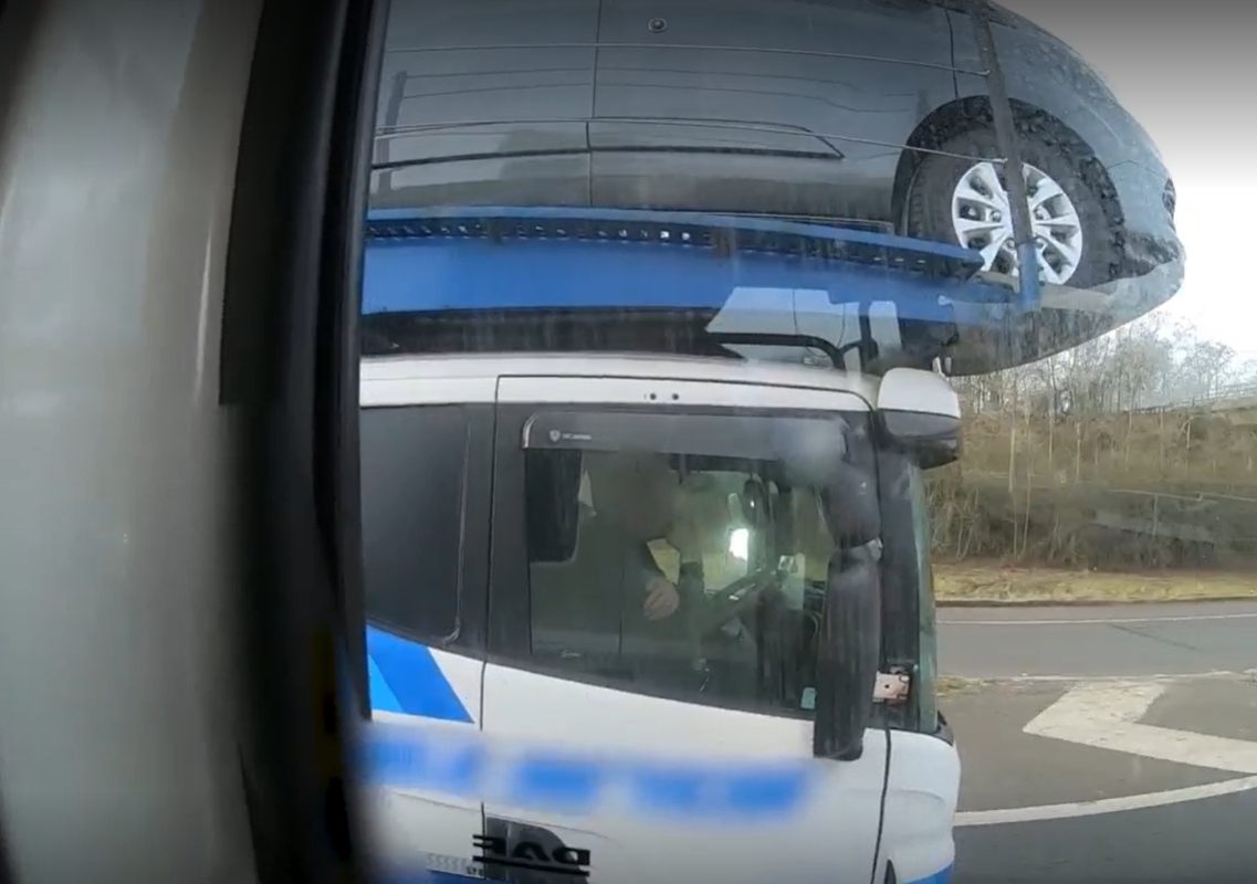 Caption: Watch footage here of the driver using his elbow to drive this transporter along the M40 near Gaydon in Warwickshire